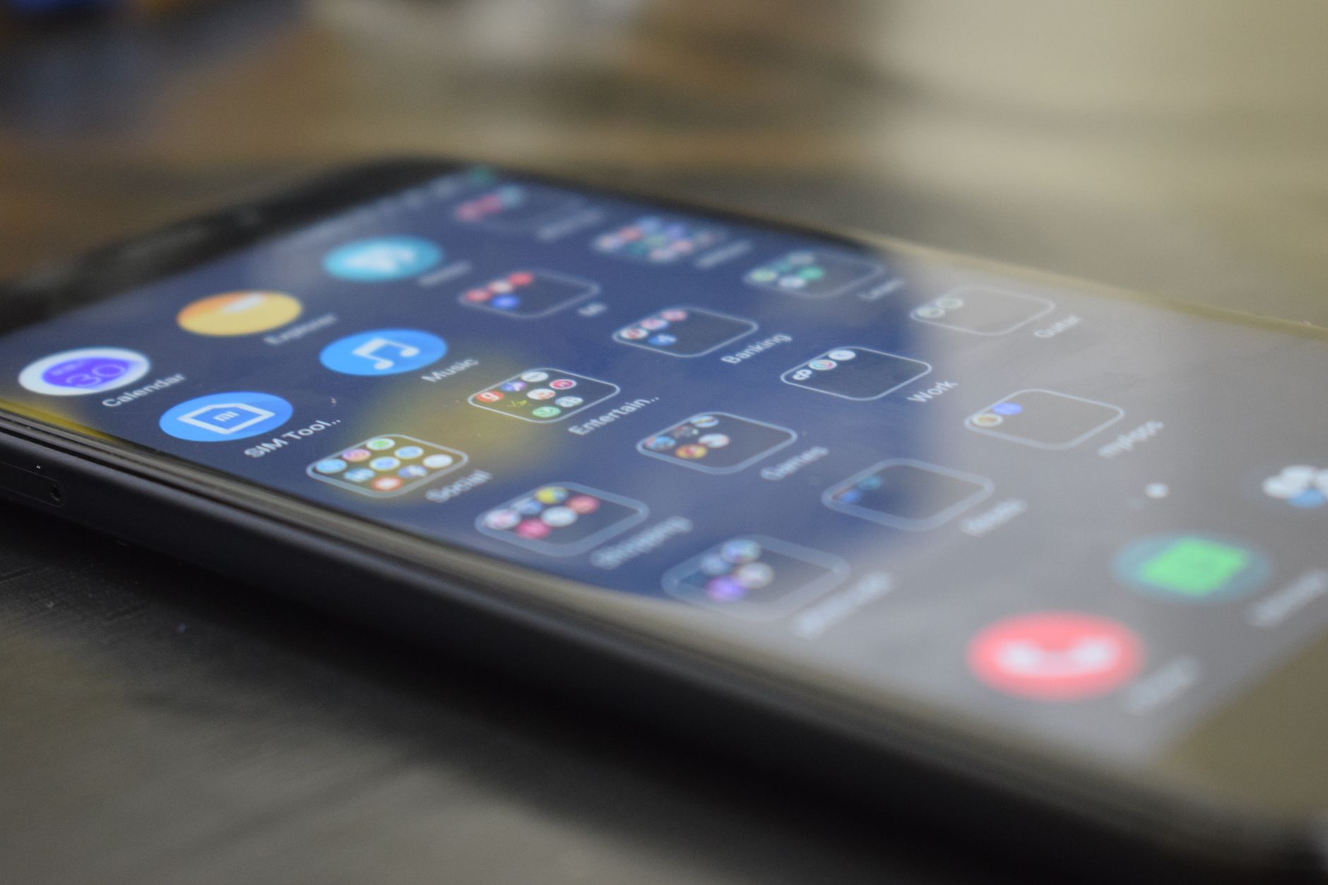 Close-up shot of a smartphone screen showing various app icons, indicating digital