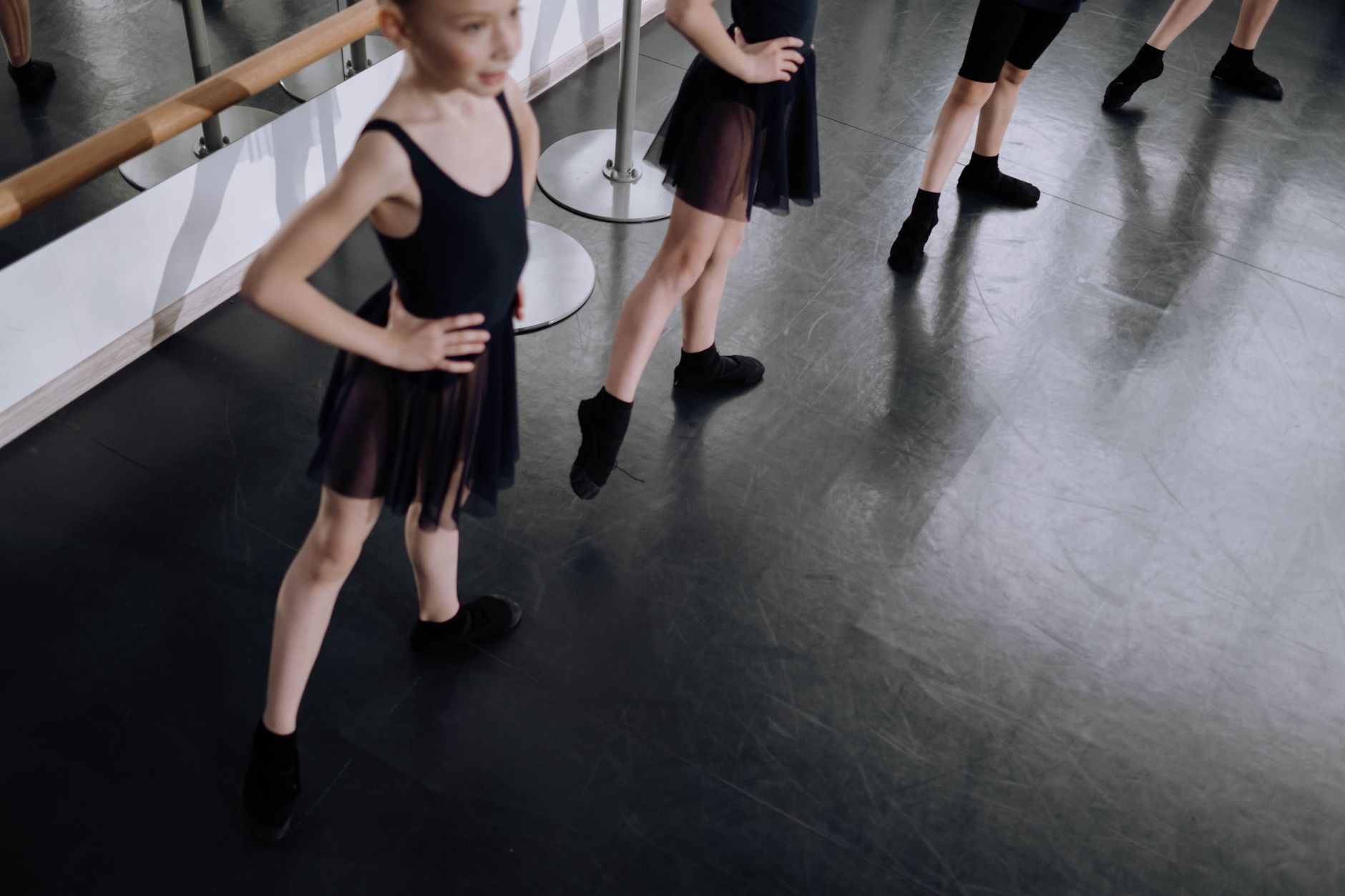 Young ballet dancers in a studio with focus on feet and pose