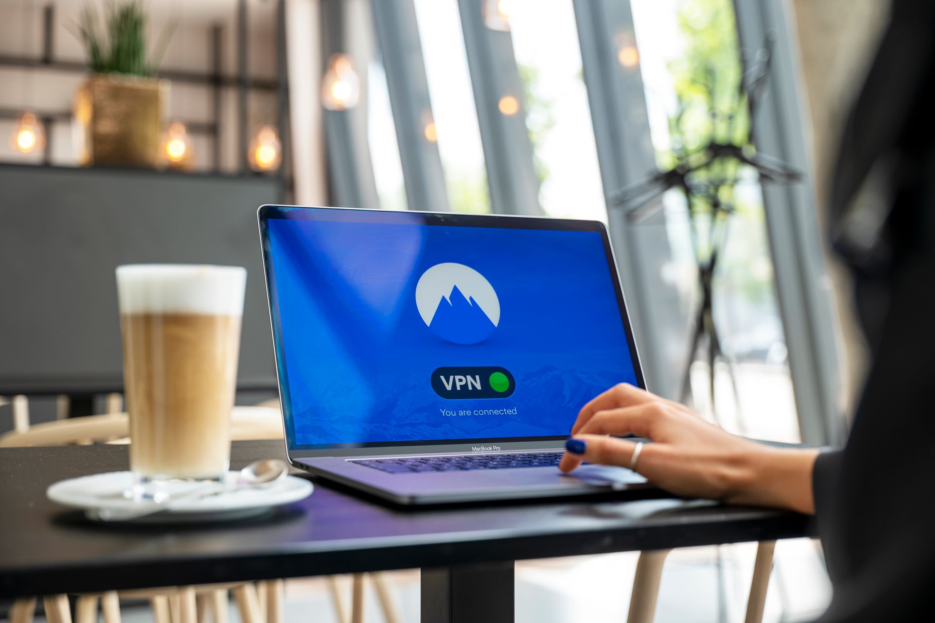 A person using a laptop with a VPN connection in a modern