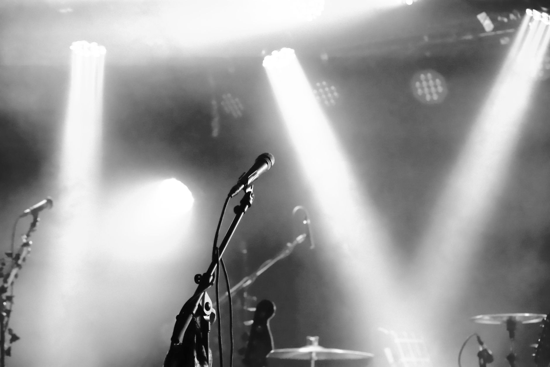Eerie black and white stage setup with microphones and spotlights ready for