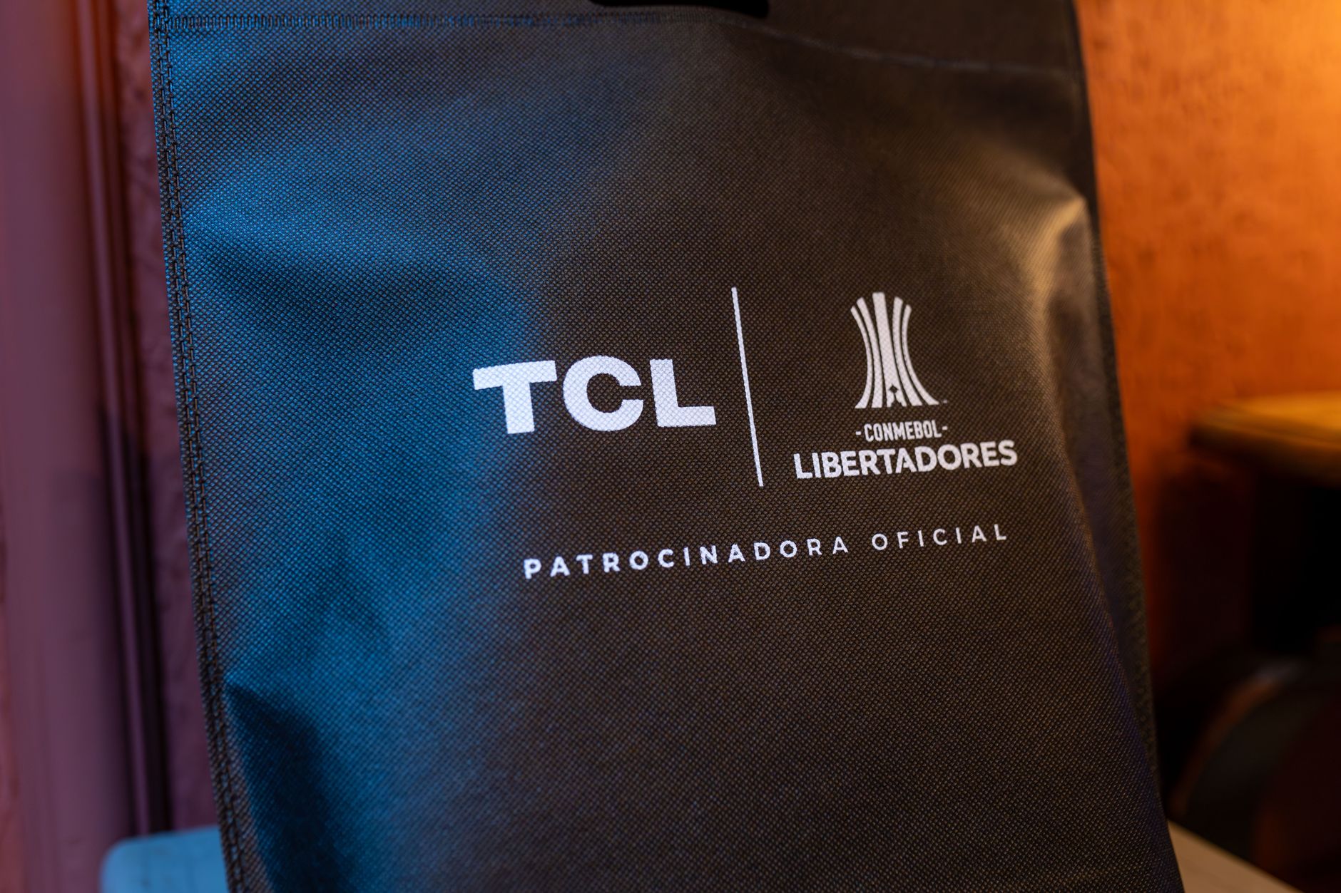 Close-up of a black sponsorship bag showing TCL and CONMEBOL Libertadores logos