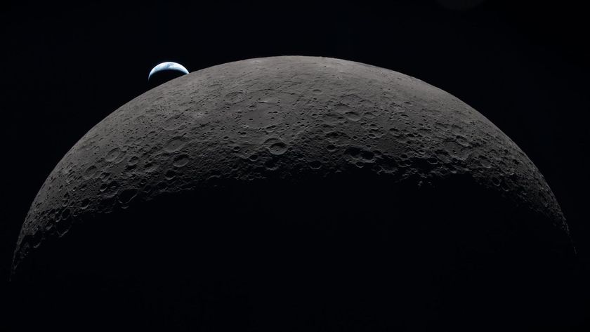 A view of the moon in the foreground with a small Earth