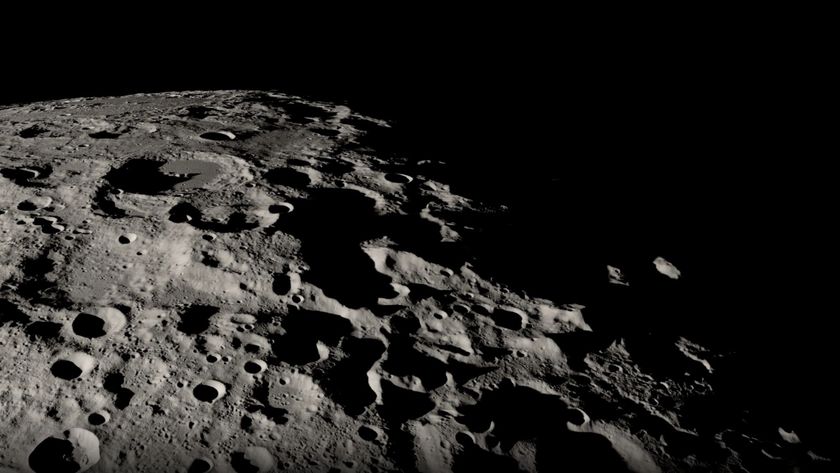 A close up of the moon's black and white, heavily cratered surface.
