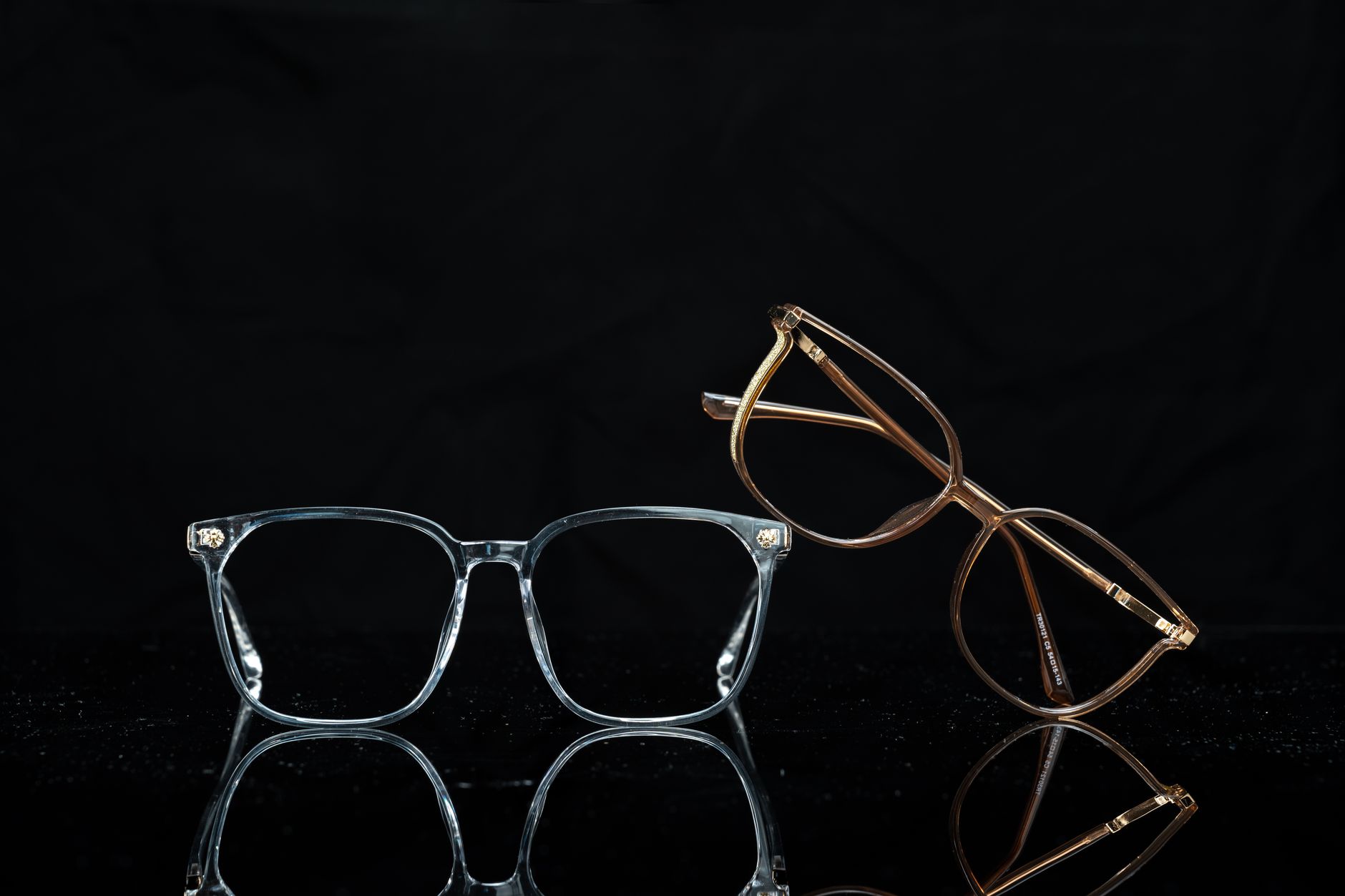 Stylish pair of eyeglasses displayed elegantly against a black background.