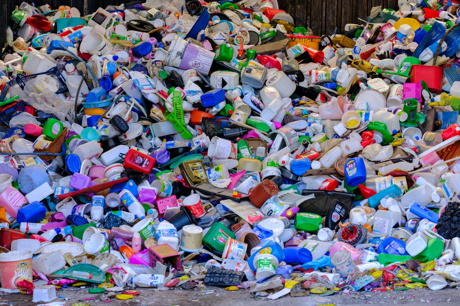 Massive colorful collection of used plastic bottles and containers in a recycling