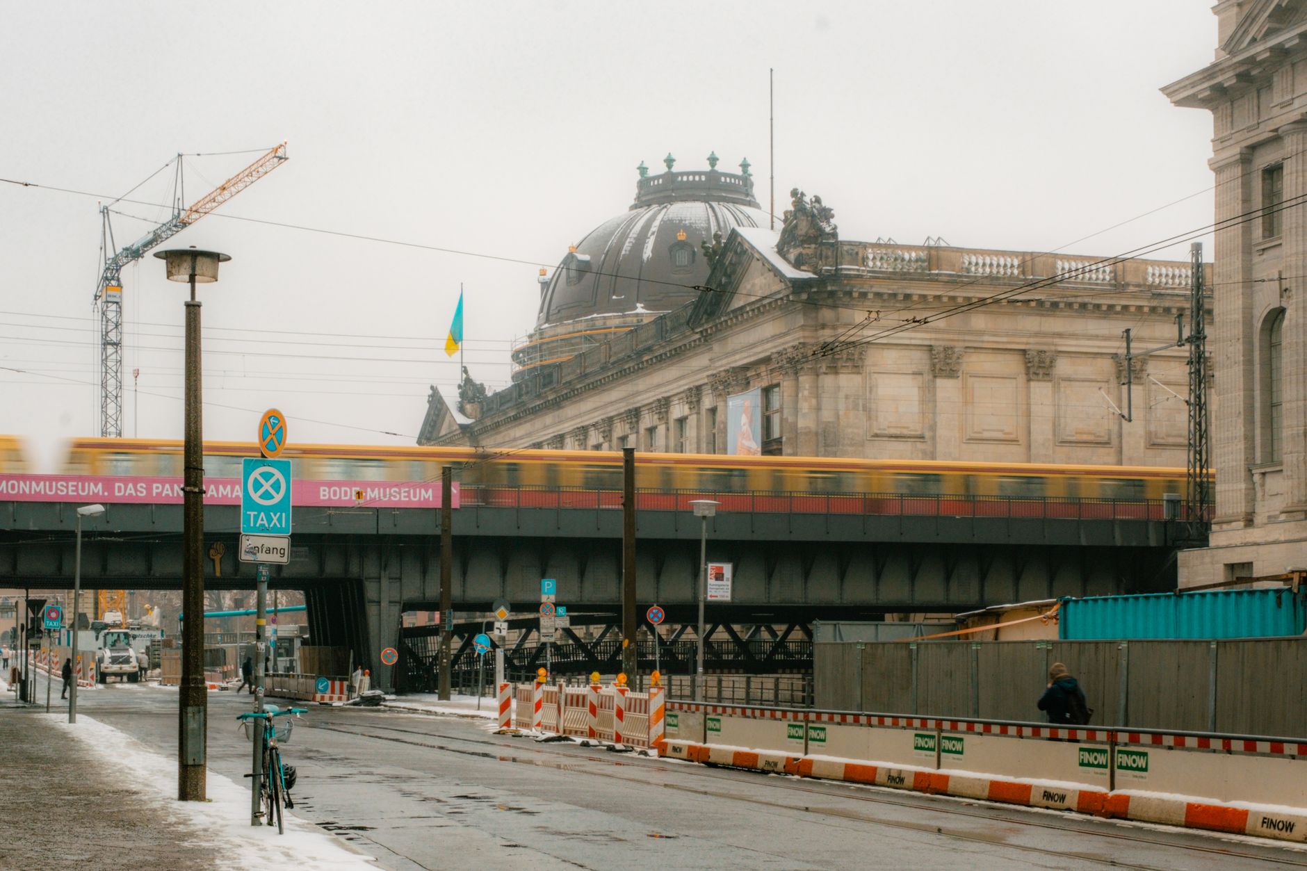 Urban Berlin scene featuring Bode Museum with train and winter ambiance.