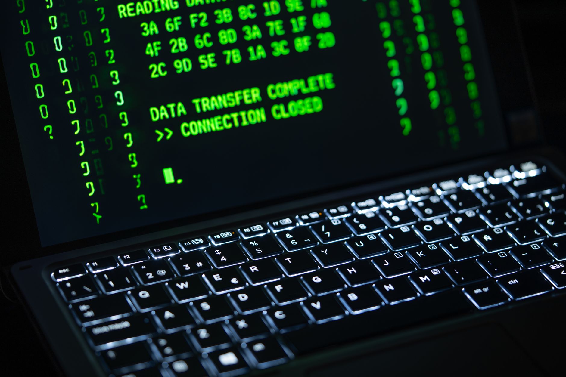 Close-up of a laptop screen displaying green code text. Perfect for cybersecurity