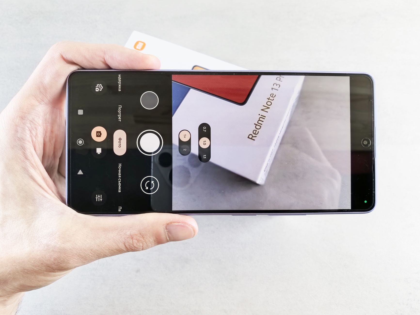 Close-up of a smartphone camera app focusing on a Redmi Note 13