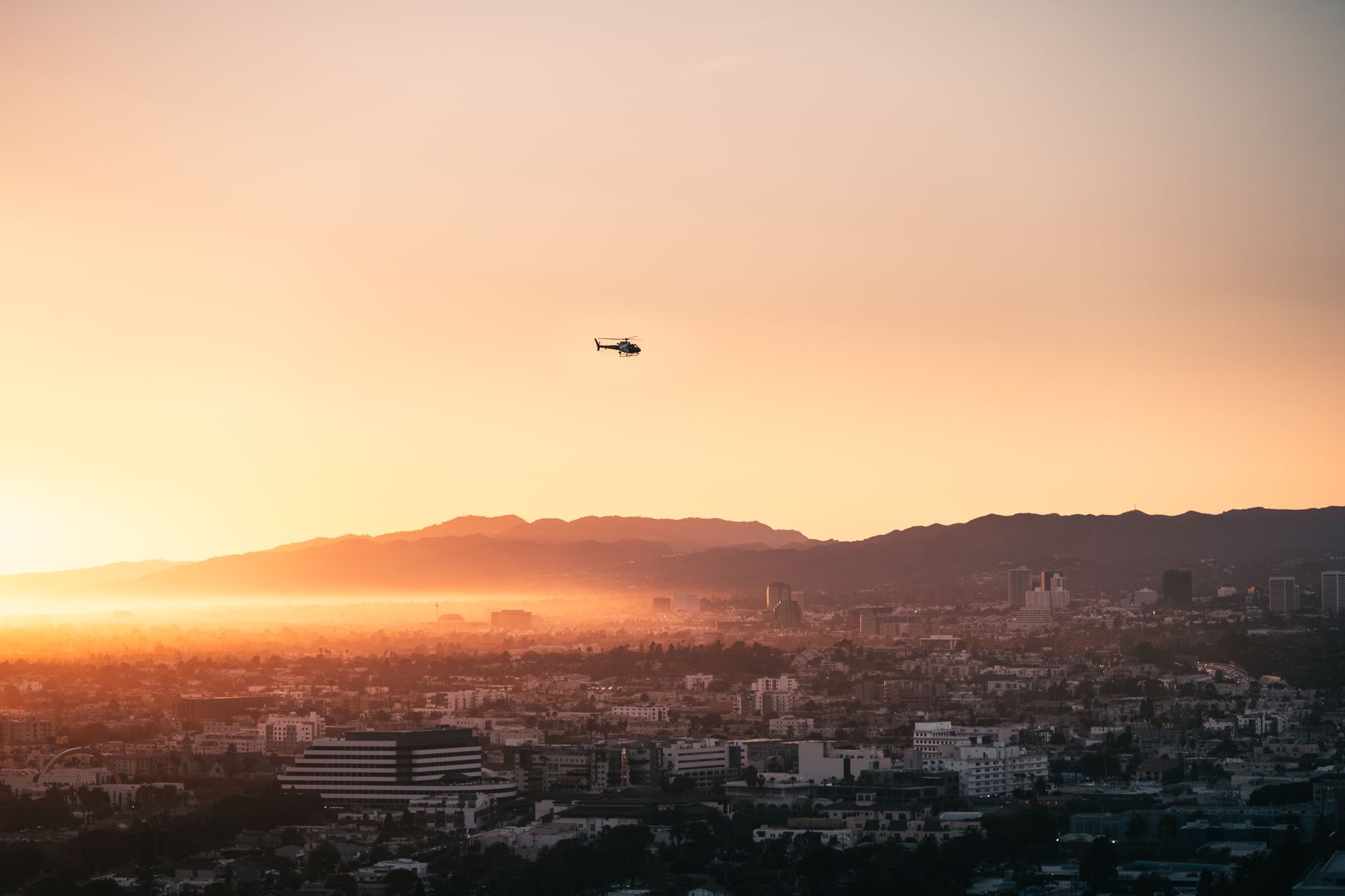 A breathtaking aerial view of Los Angeles with a helicopter flying at