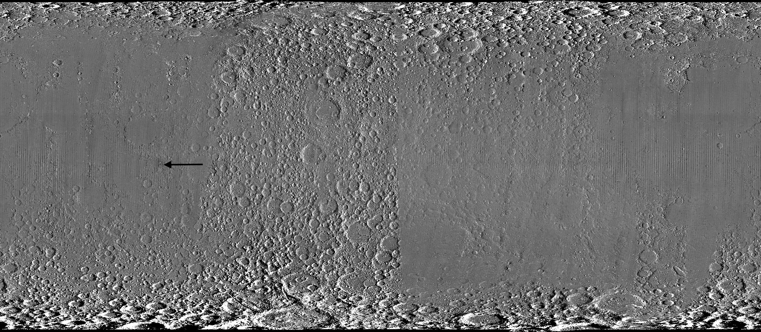 Wide black-and-white image of a rough, uneven surface densely covered with circular