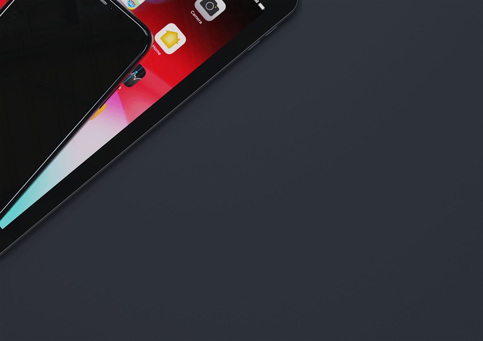 Top view of smartphone and tablet on dark gray surface with ample