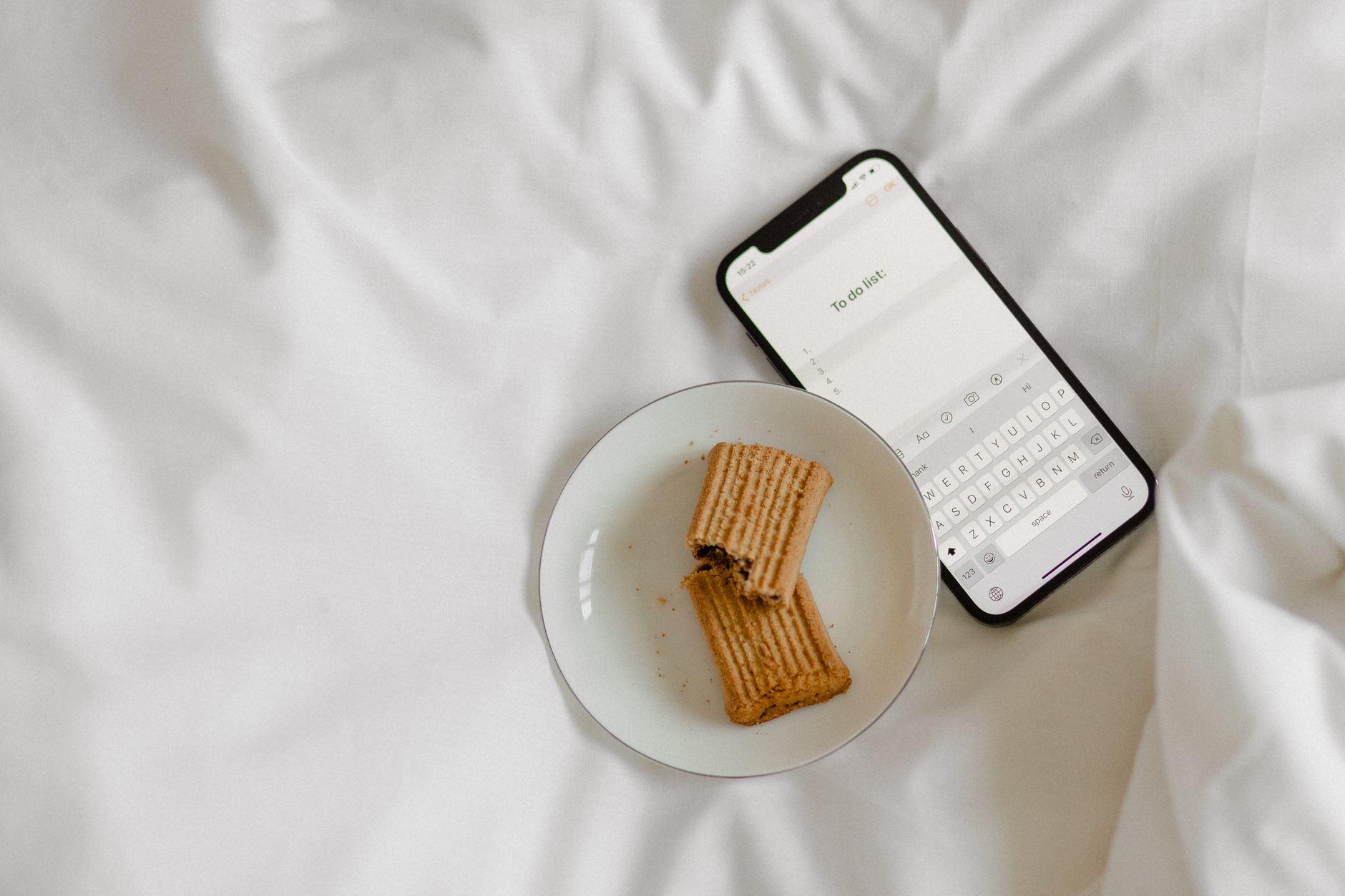 Cozy morning scene with cookies on a plate beside a smartphone on