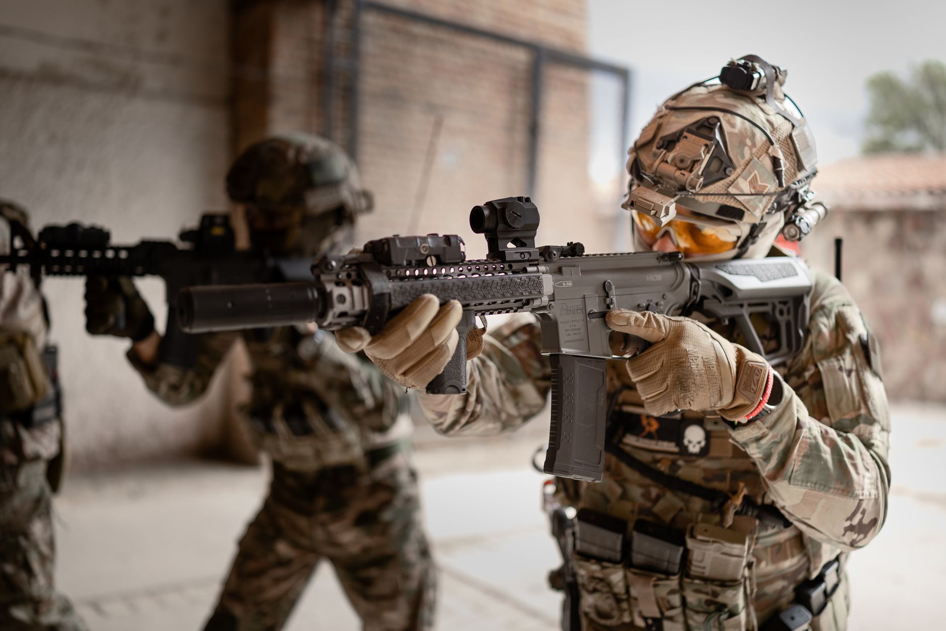 Armored soldiers in action during indoor training exercises, equipped with tactical gear.