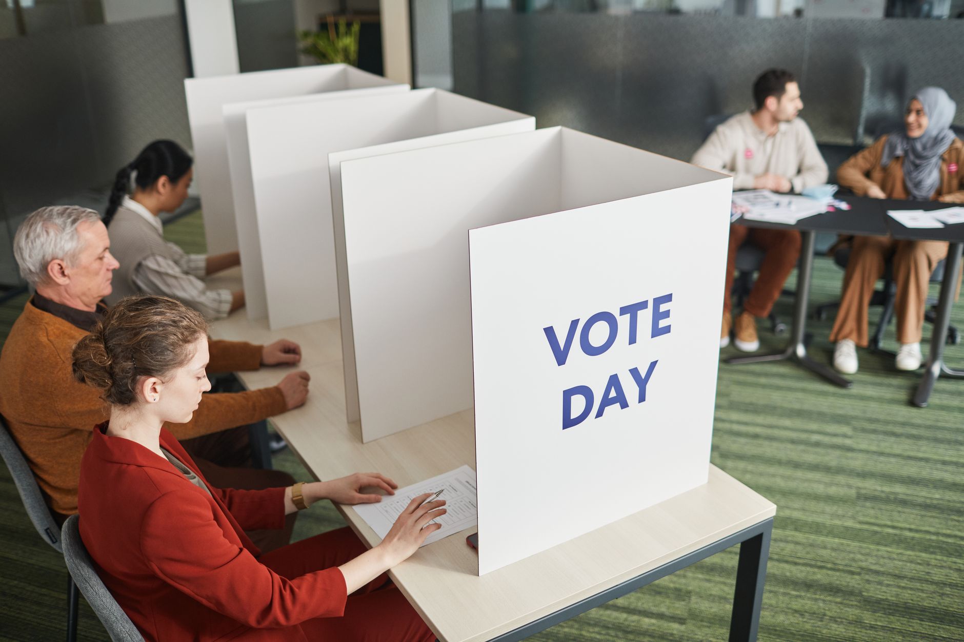 People casting votes in a polling station on election day, emphasizing civic
