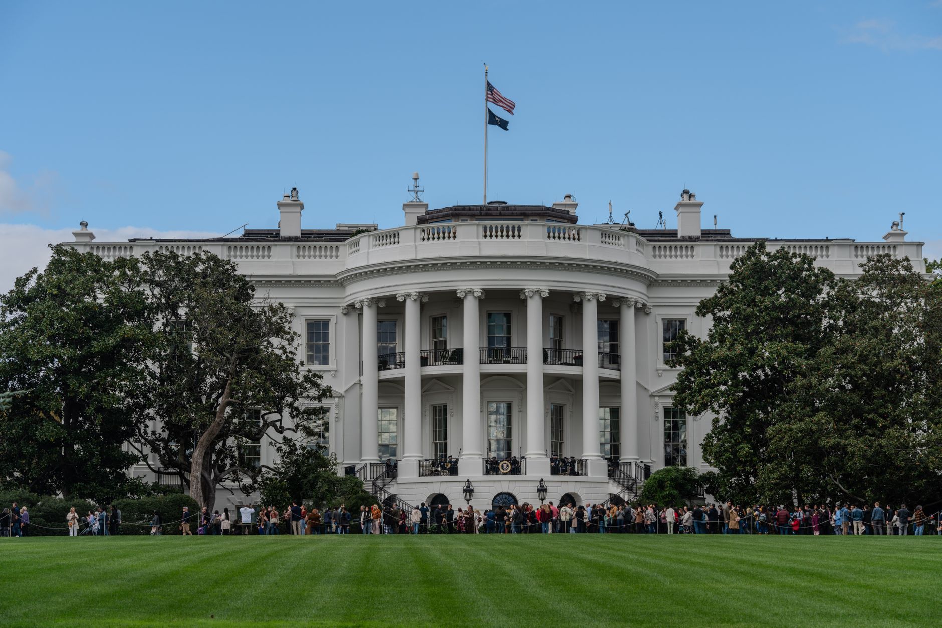 A picturesque view of the White House with the American flag in