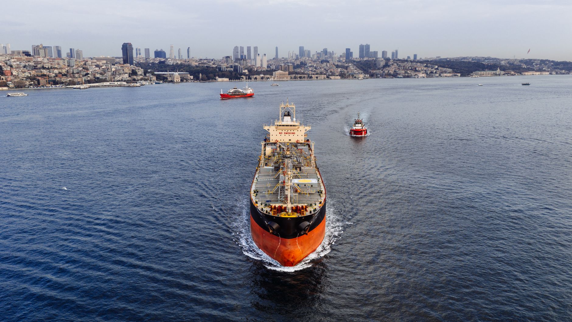 A stunning aerial shot of a cargo ship navigating the Bosphorus Strait