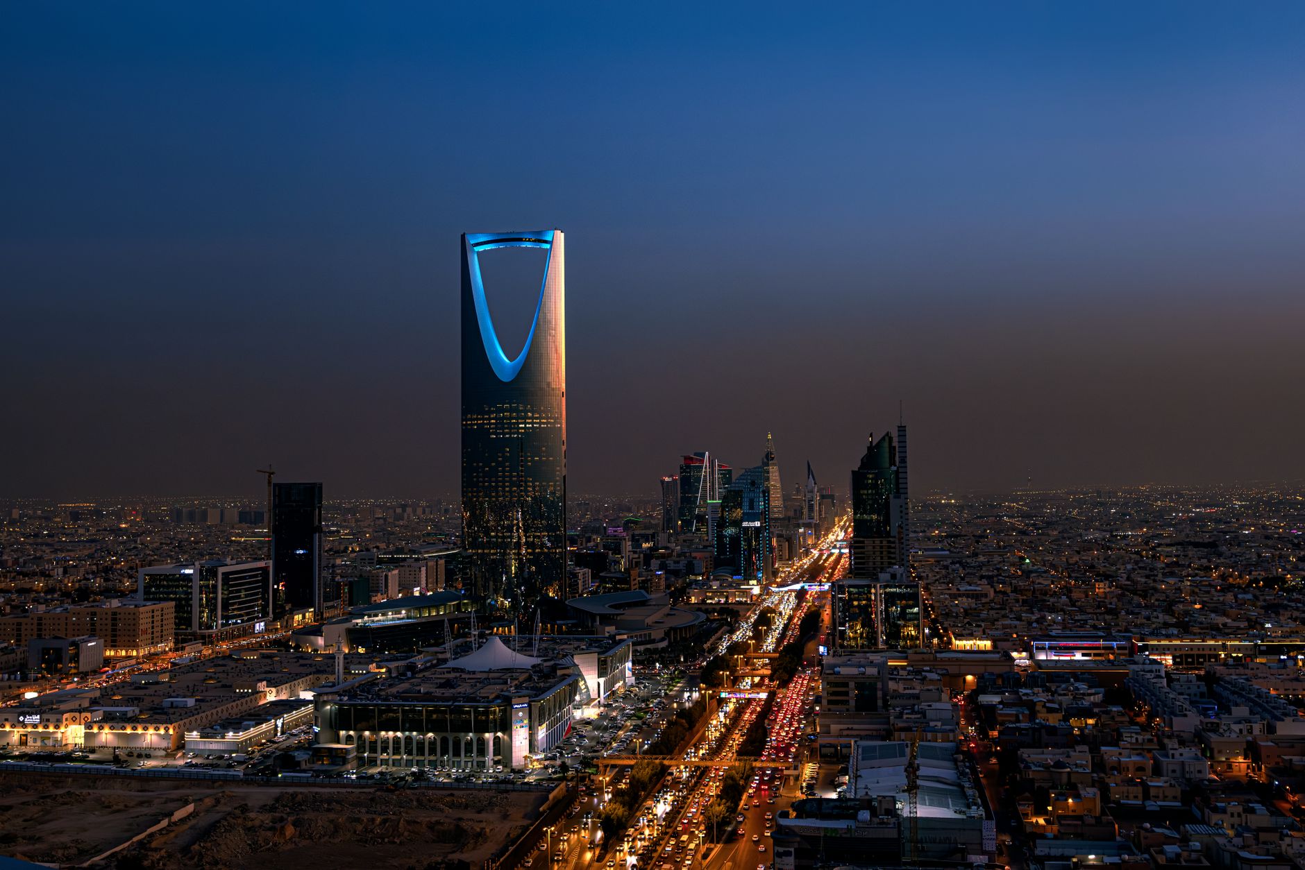 A breathtaking aerial view of Riyadh at night featuring the iconic Kingdom