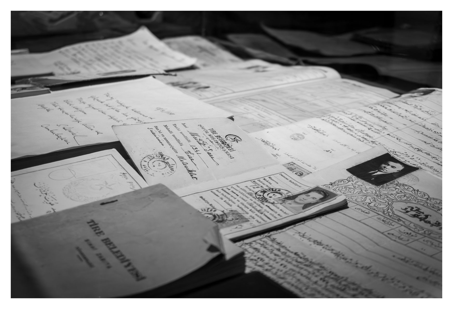 A collection of historical documents and identity papers displayed in Istanbul, Türkiye.