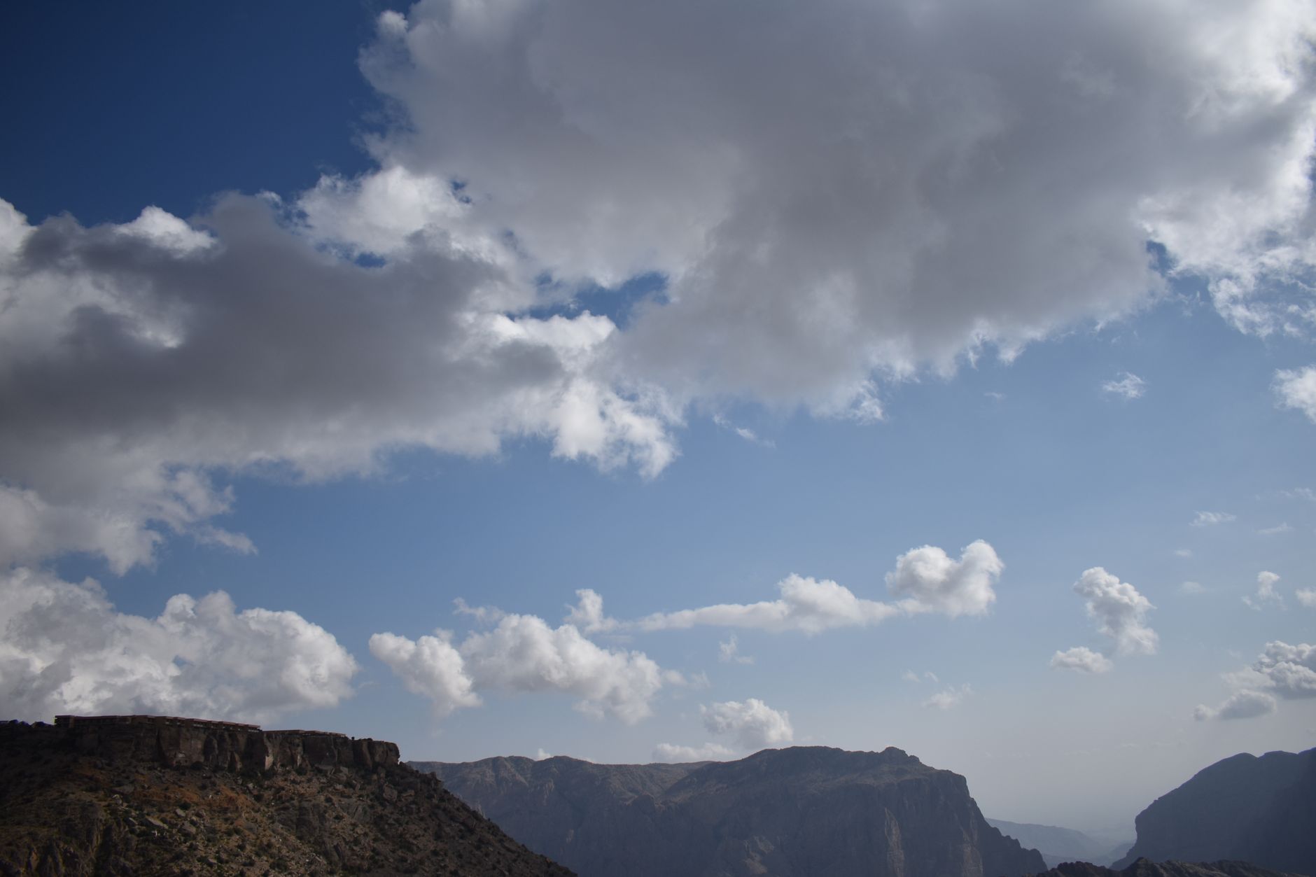 Vast mountains beneath a dramatic cloudscape, perfect for nature enthusiasts.