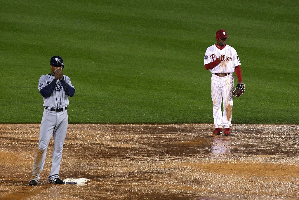 PHILADELPHIA - OCTOBER 27: Jimmy Rollins #11 (R) of the Philadelphia Phillies and B.J. Upton #2 of the Tampa Bay Rays stand on the rain soaked field during the top of the sixth innning during game fiv