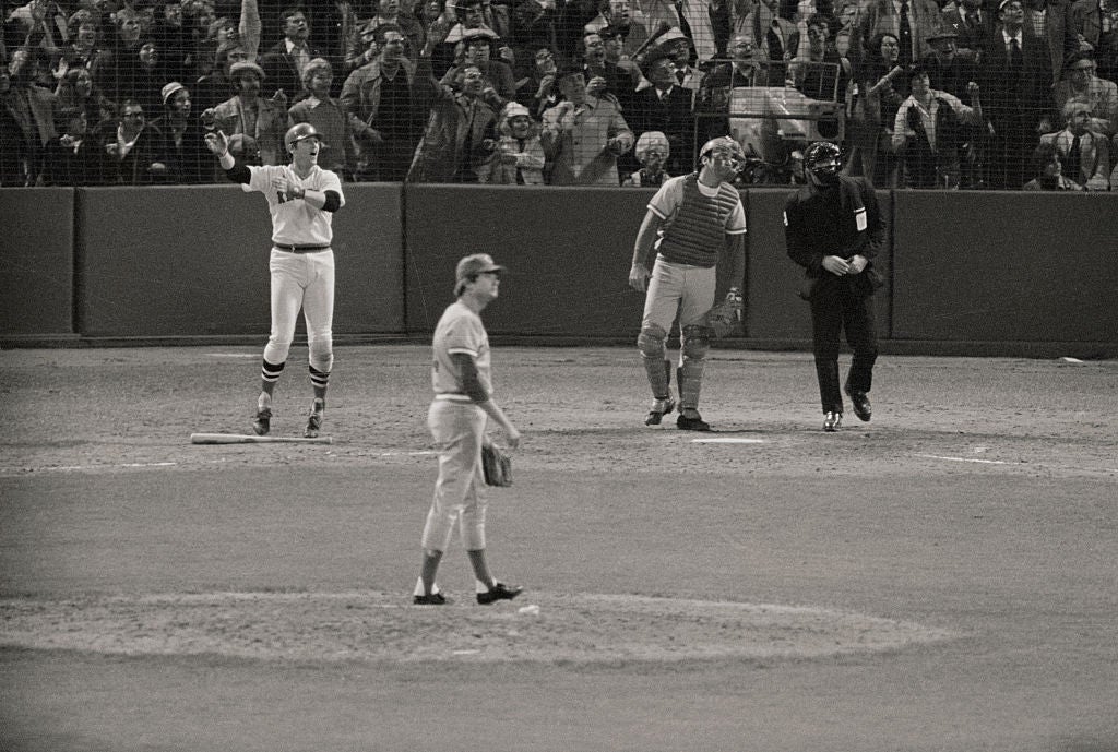 (Original Caption) Carlton Fisk hits the ball in the 12th inning for
