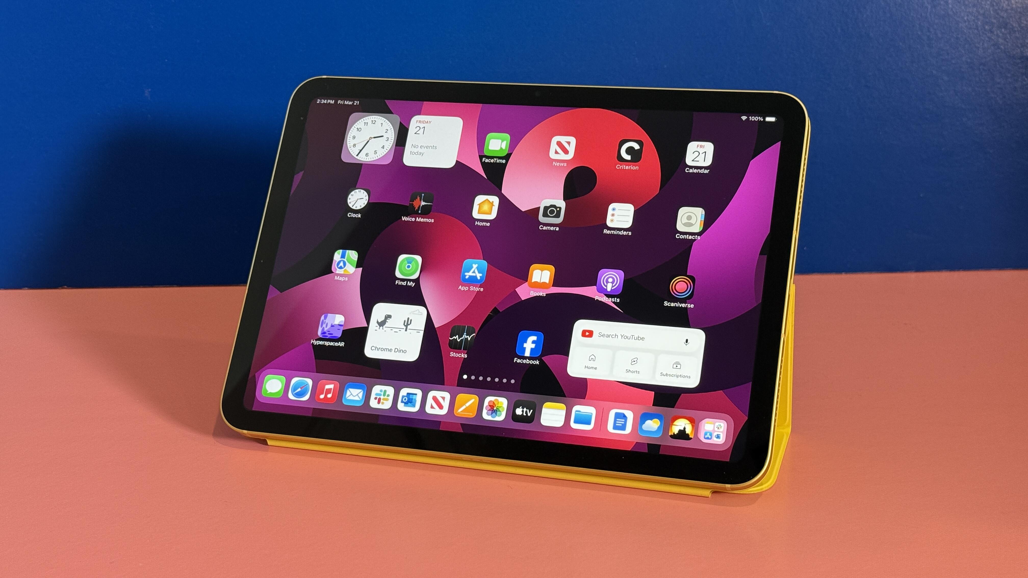 iPad standing up on table with many apps shown on the home
