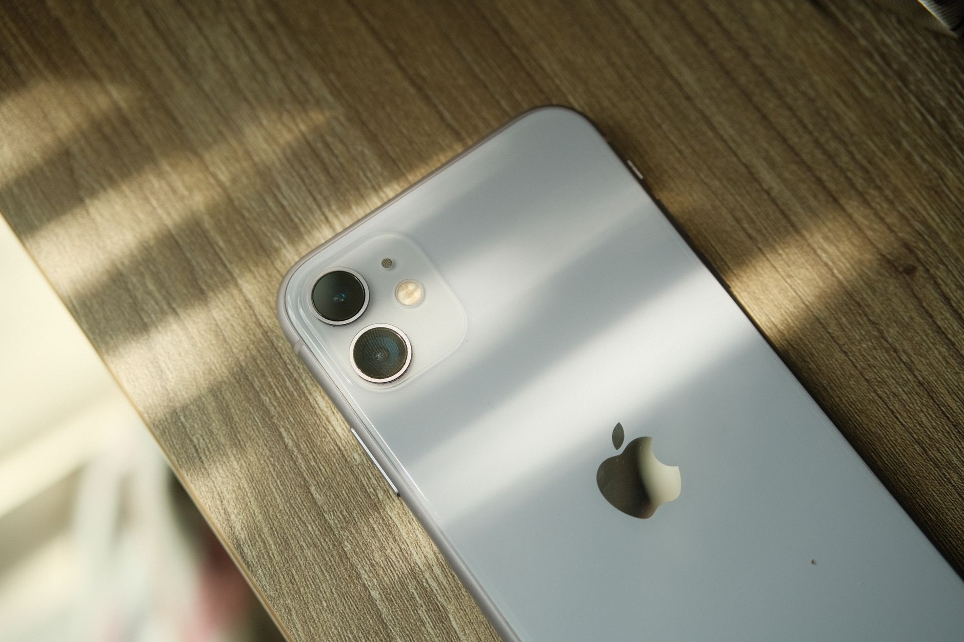 A close-up view of a smartphone with a dual-camera setup placed on