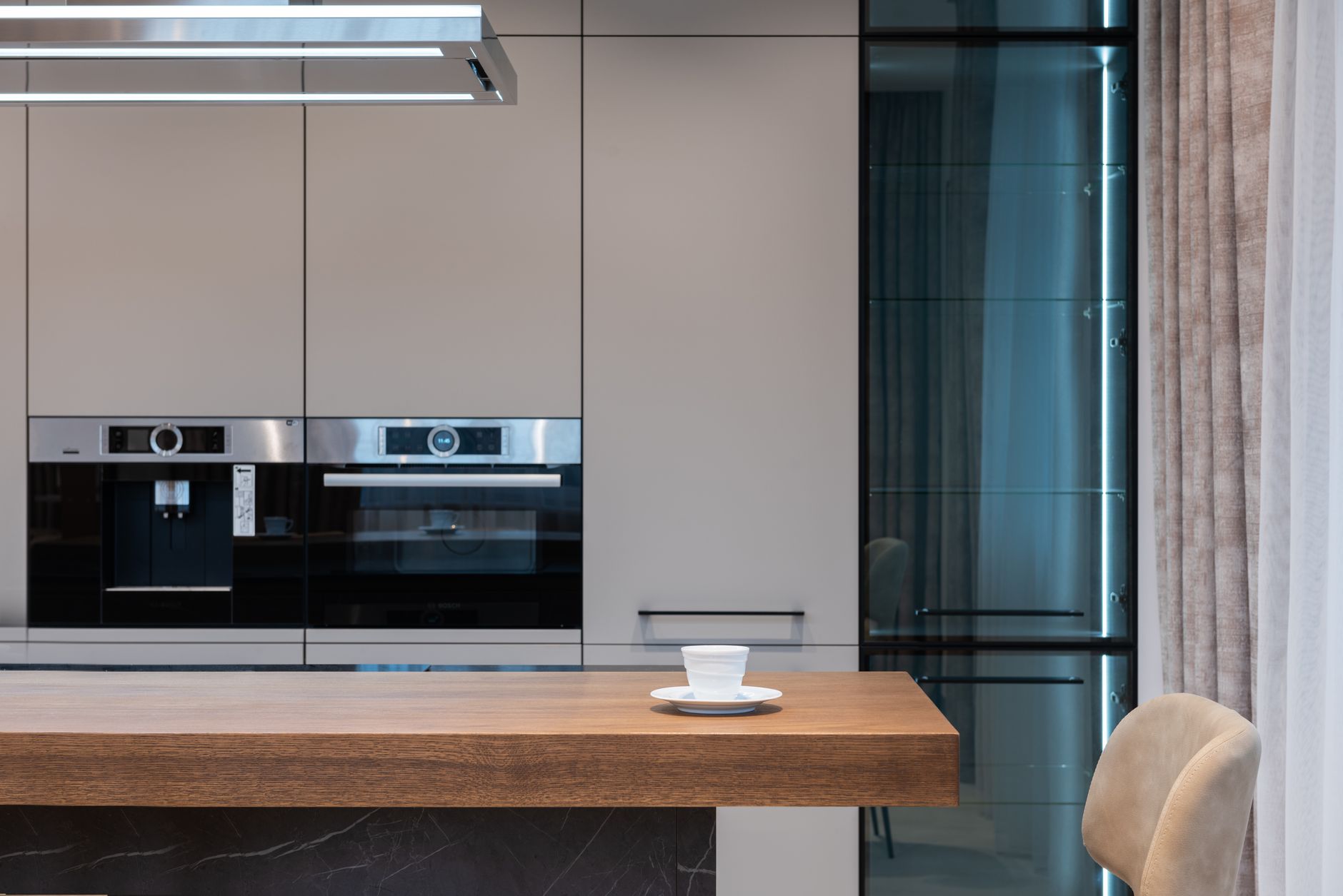 Modern room with kitchenware and counter with coffee cup near chairs and