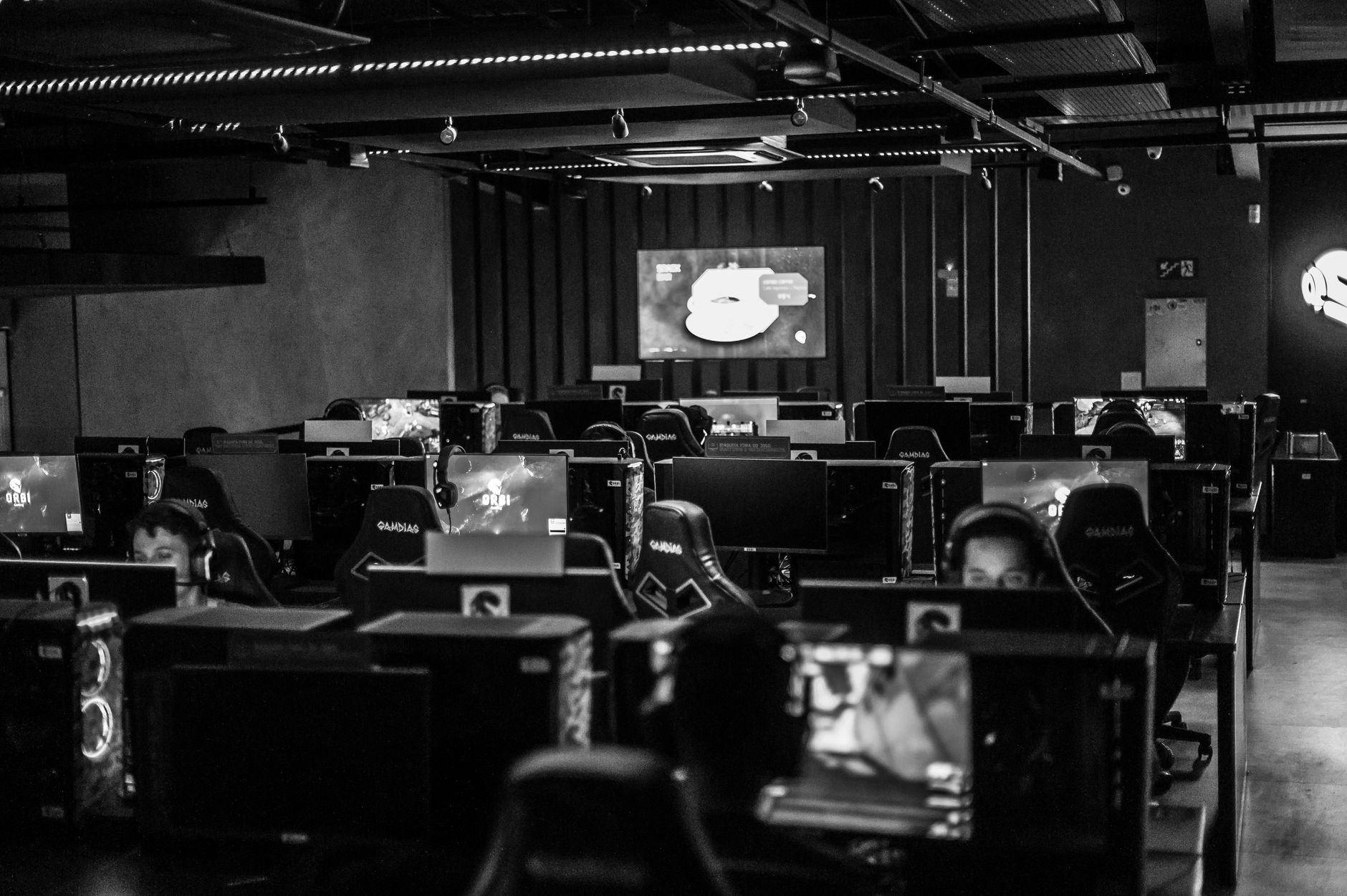 Black and white view of an active esports gaming studio with players