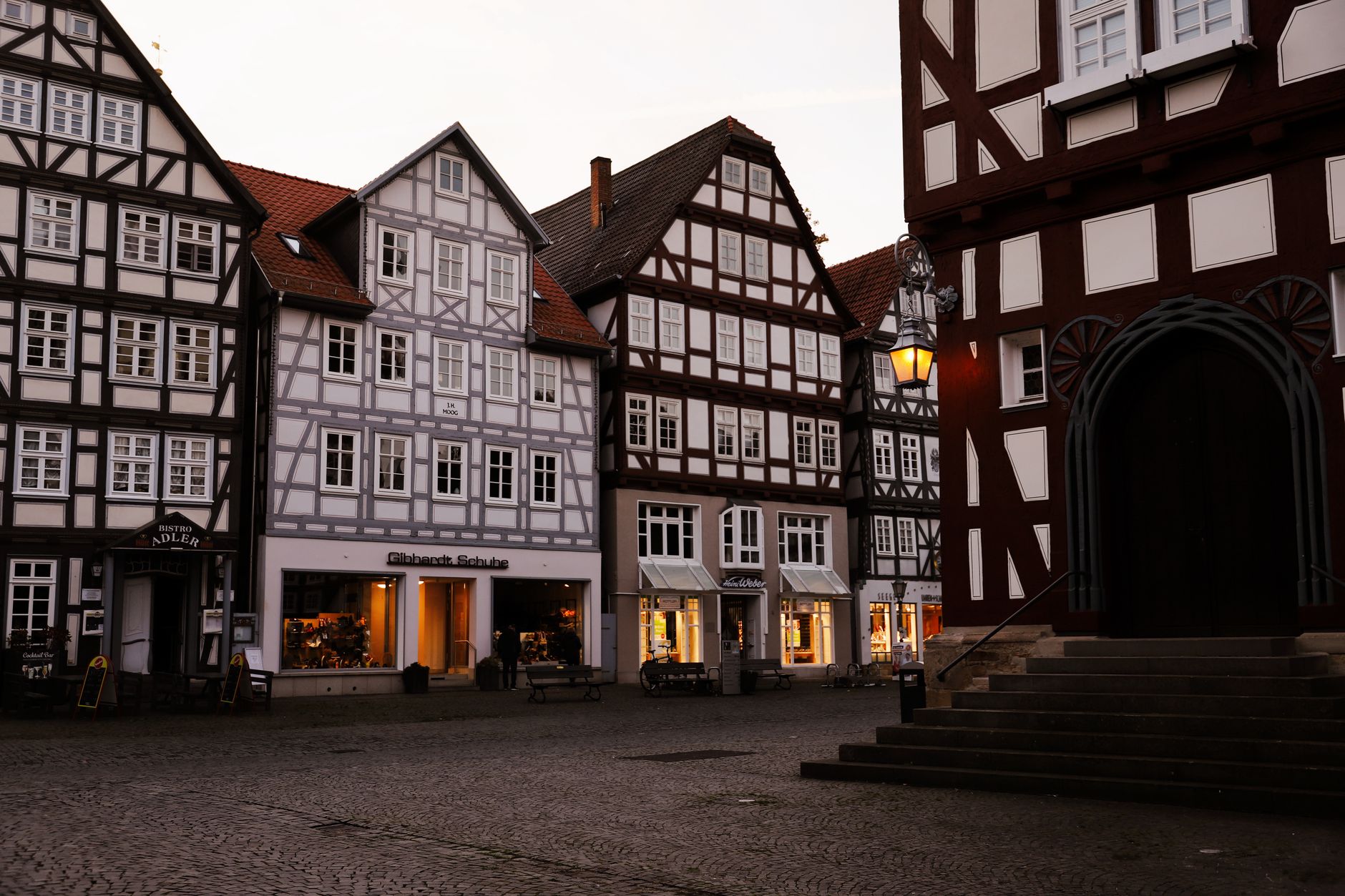 Picturesque timber-framed buildings at dusk in Melsungen, Germany's historic market square.
