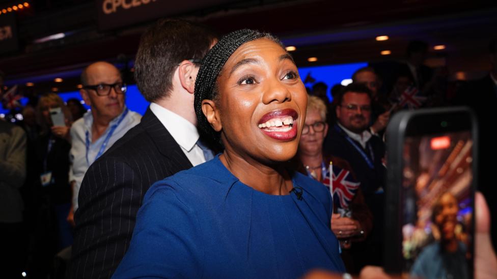Kemi Badenoch grins at supporters after leaving the stage at the Conservative