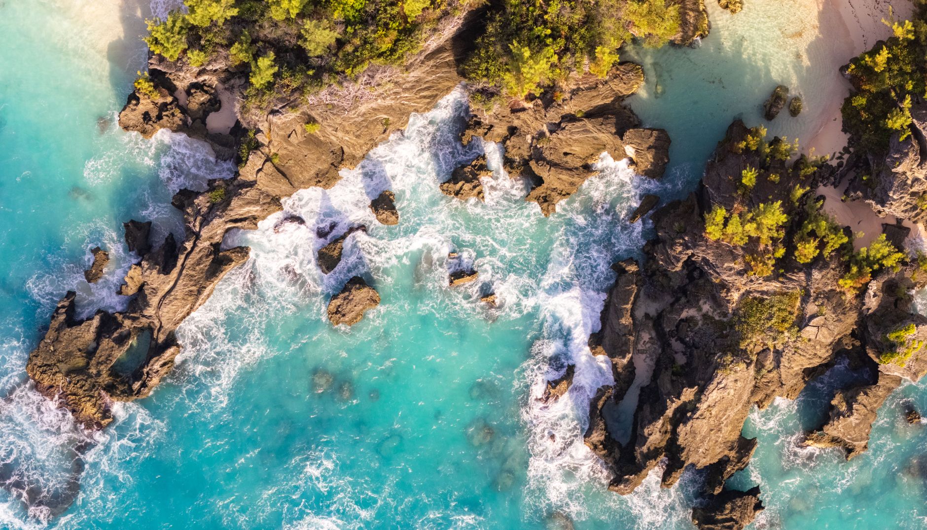 A stunning aerial view of Bermuda's rocky coastline with turquoise waters and