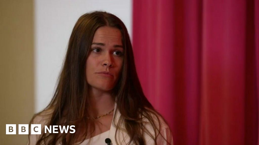 Brittany Bee is seen talking with a reporter.