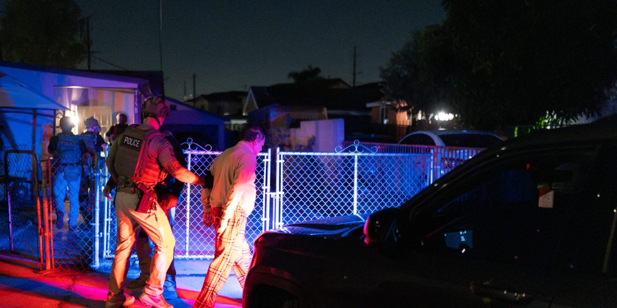 Homeland Security Investigations task force officers arrest a suspect accused of illegally registering to vote during a federal operation in Commerce.