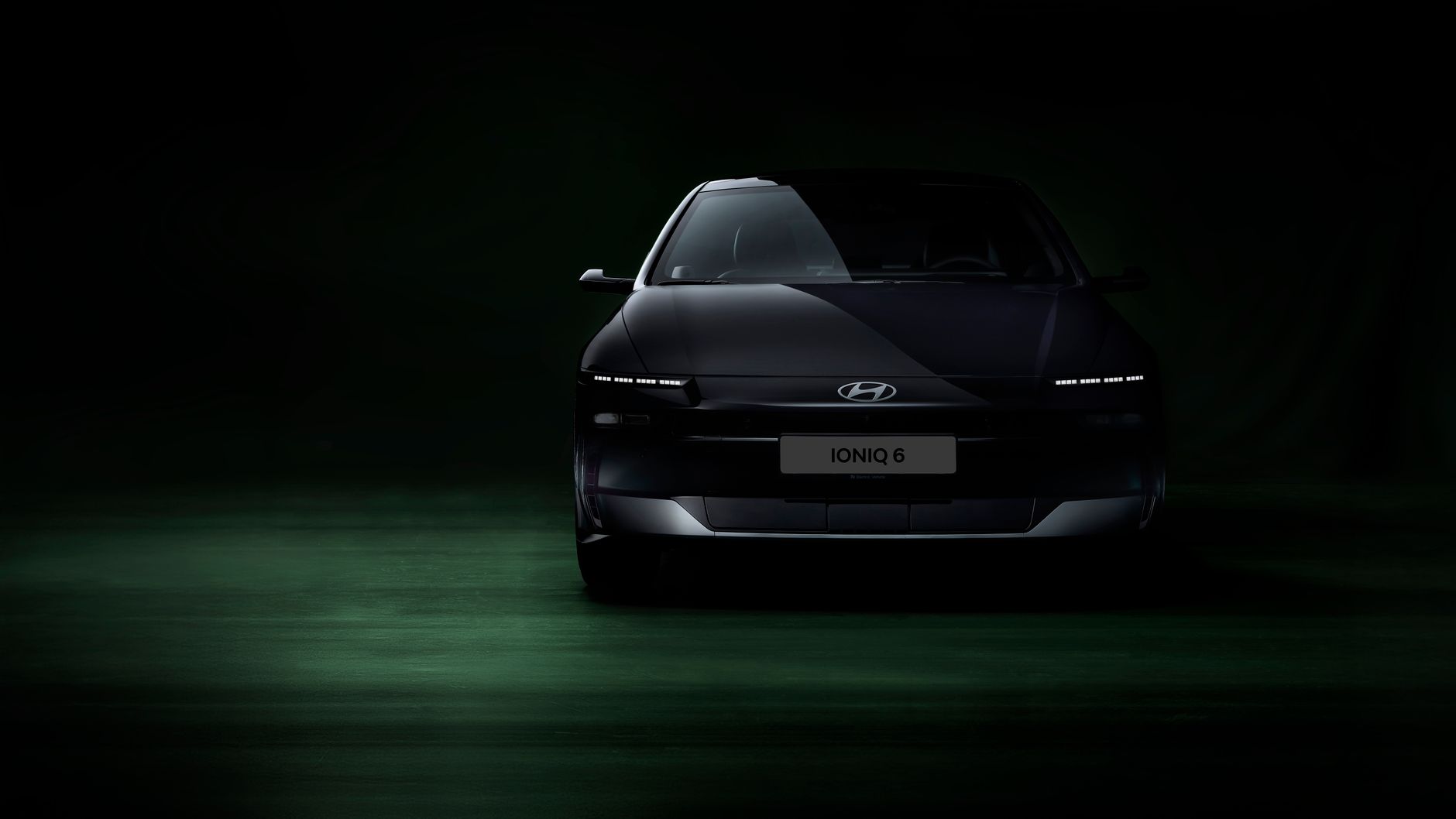 Front view of Hyundai Ioniq 6 electric car in a dimly lit