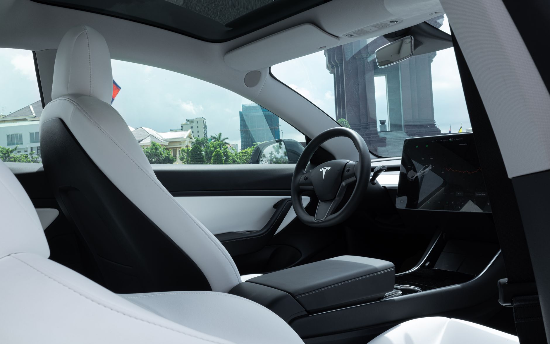 Luxurious interior of a modern electric car with white leather seats and