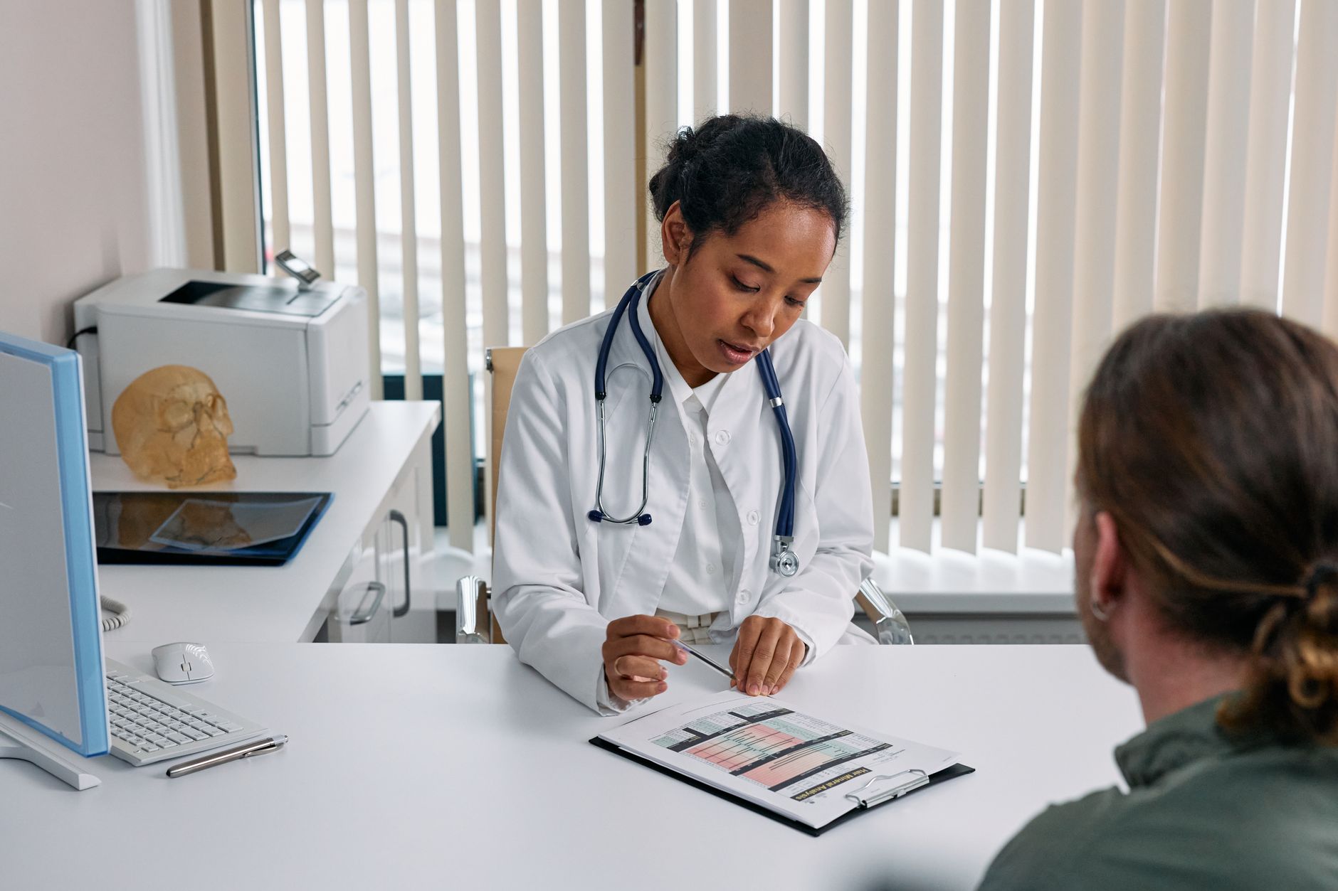 A doctor consulting with a patient in an office, discussing a medical