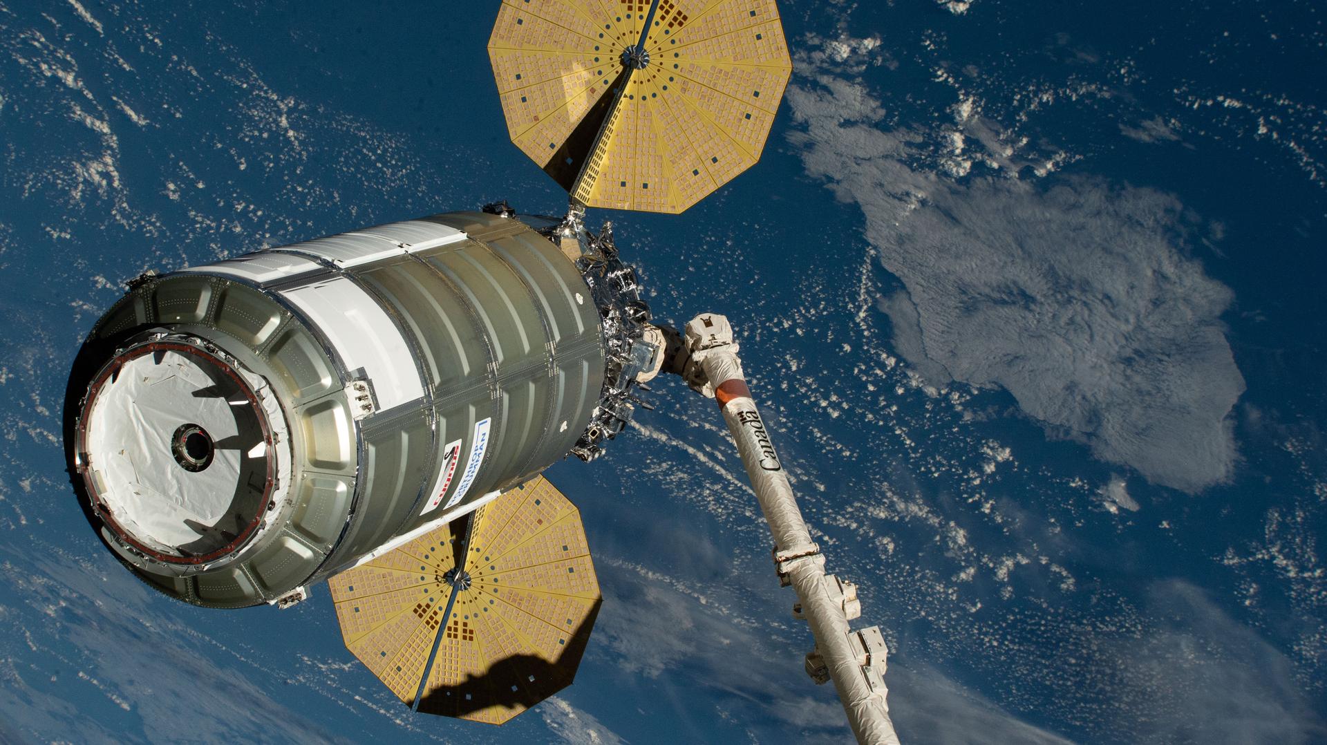 Northrop Grumman's Cygnus XL cargo spacecraft is held in the grips of