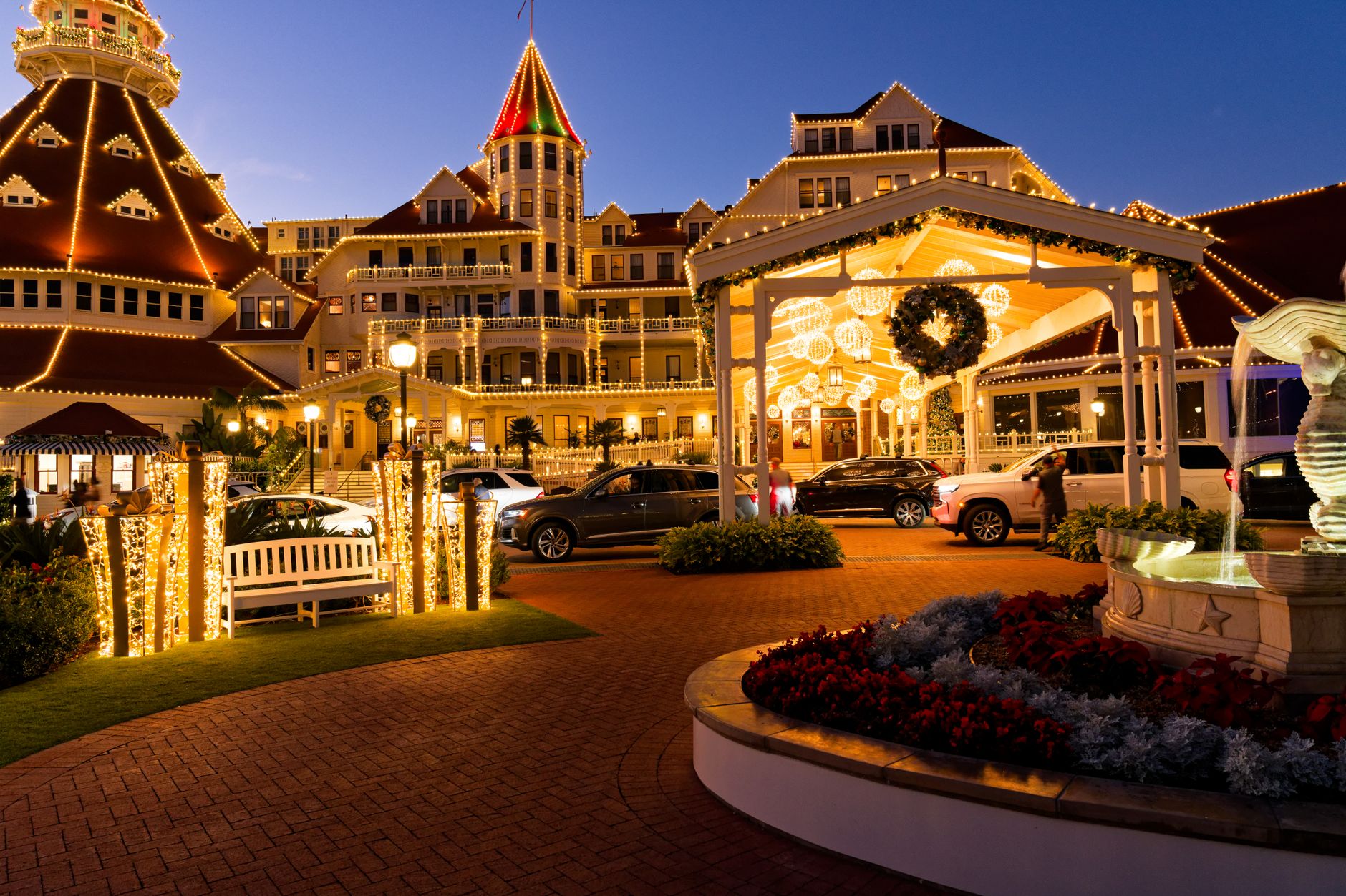 Stunning evening photo of a beautifully lit hotel with festive decorations and
