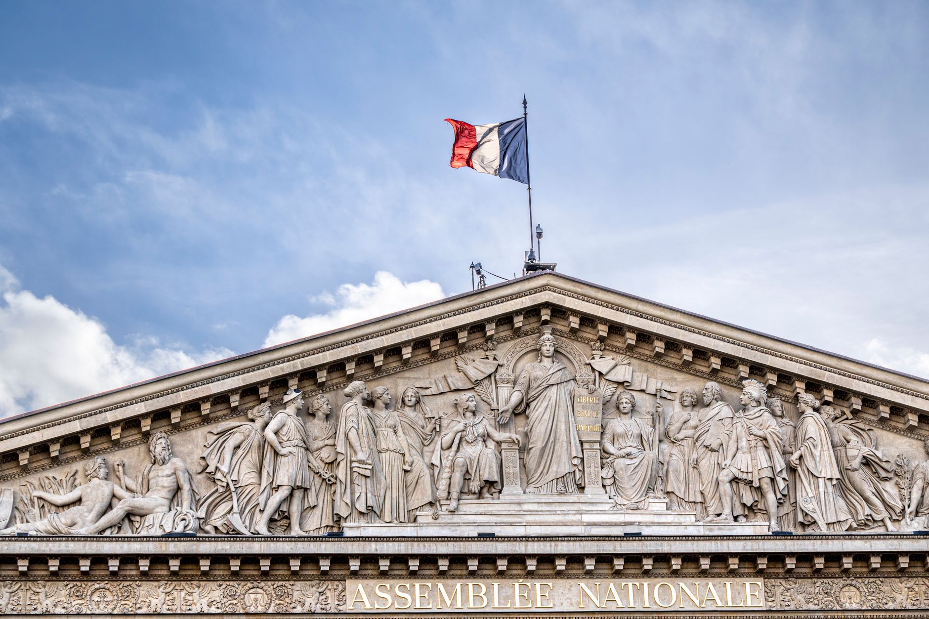 Facade of the French National Assembly building in Paris, showcasing its classical