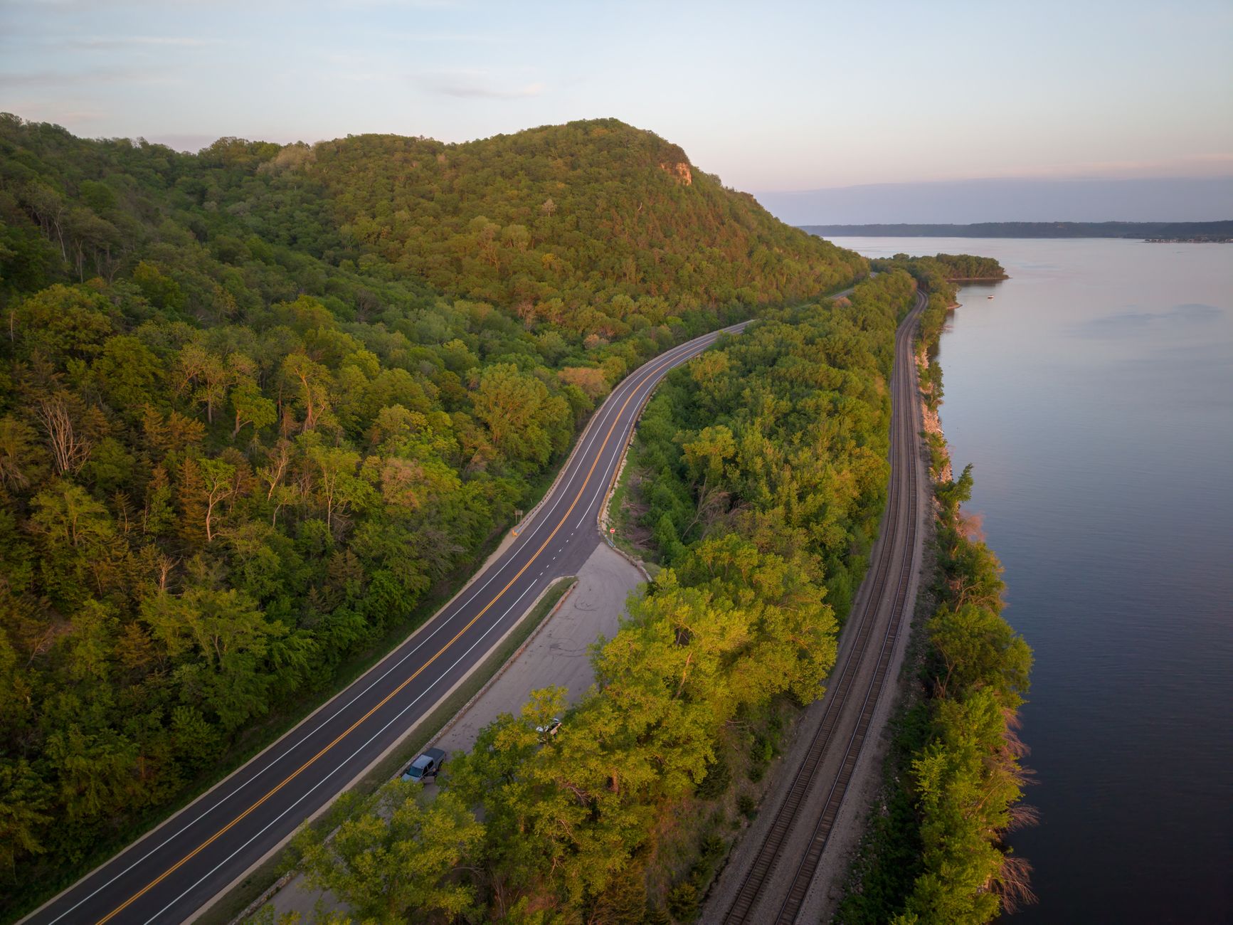 Aerial shot of a scenic highway and railway along the Mississippi River