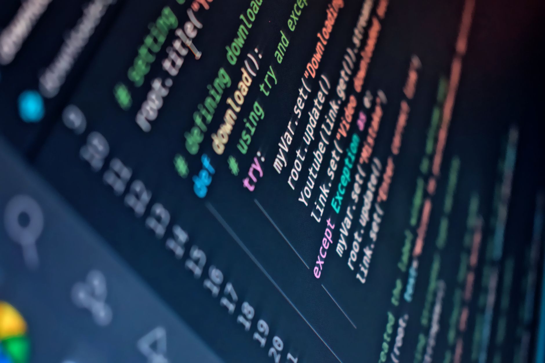 Close-up of a computer screen displaying colorful programming code with depth of