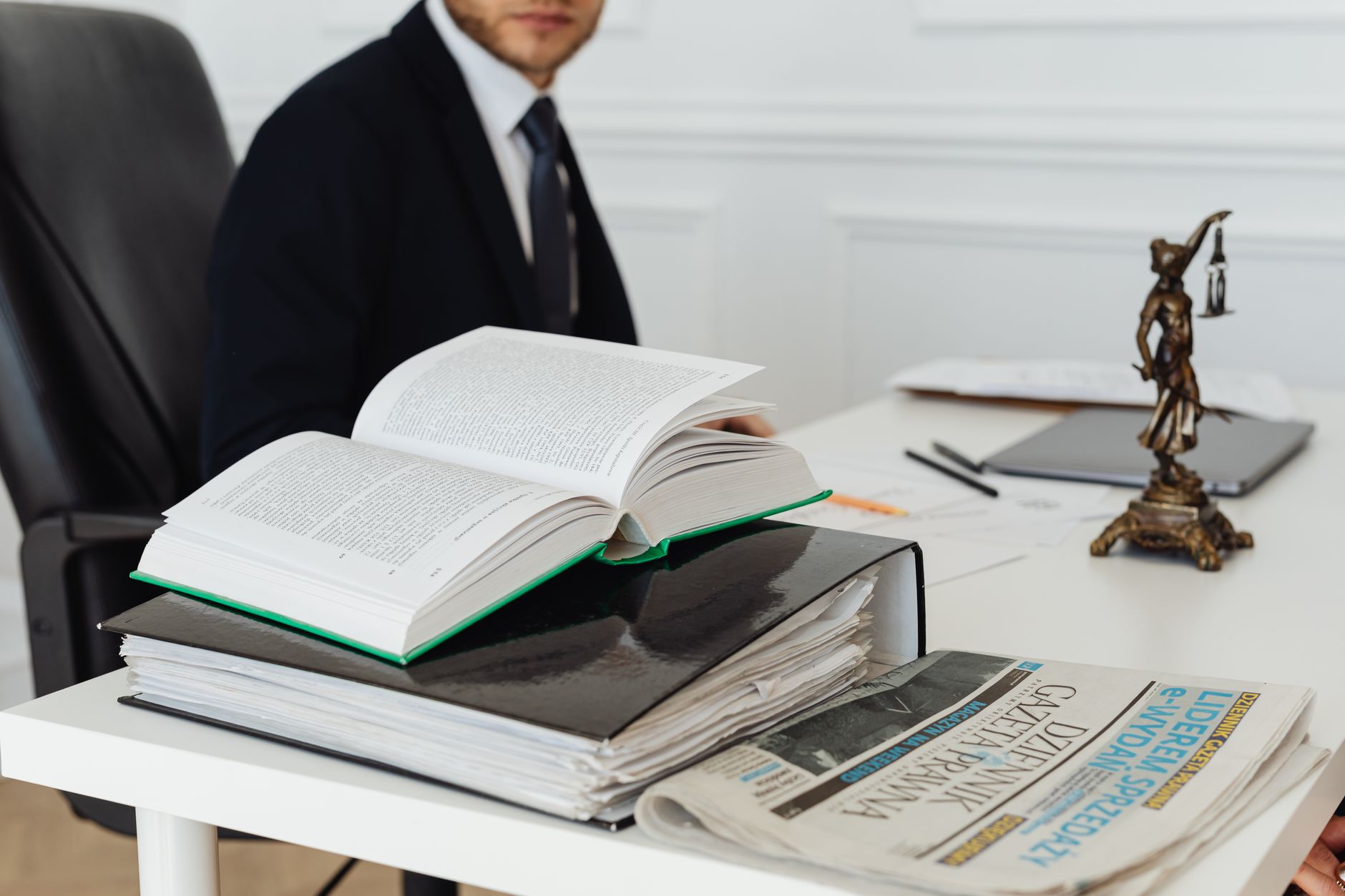 A lawyer sitting at a desk with legal books, documents, and a