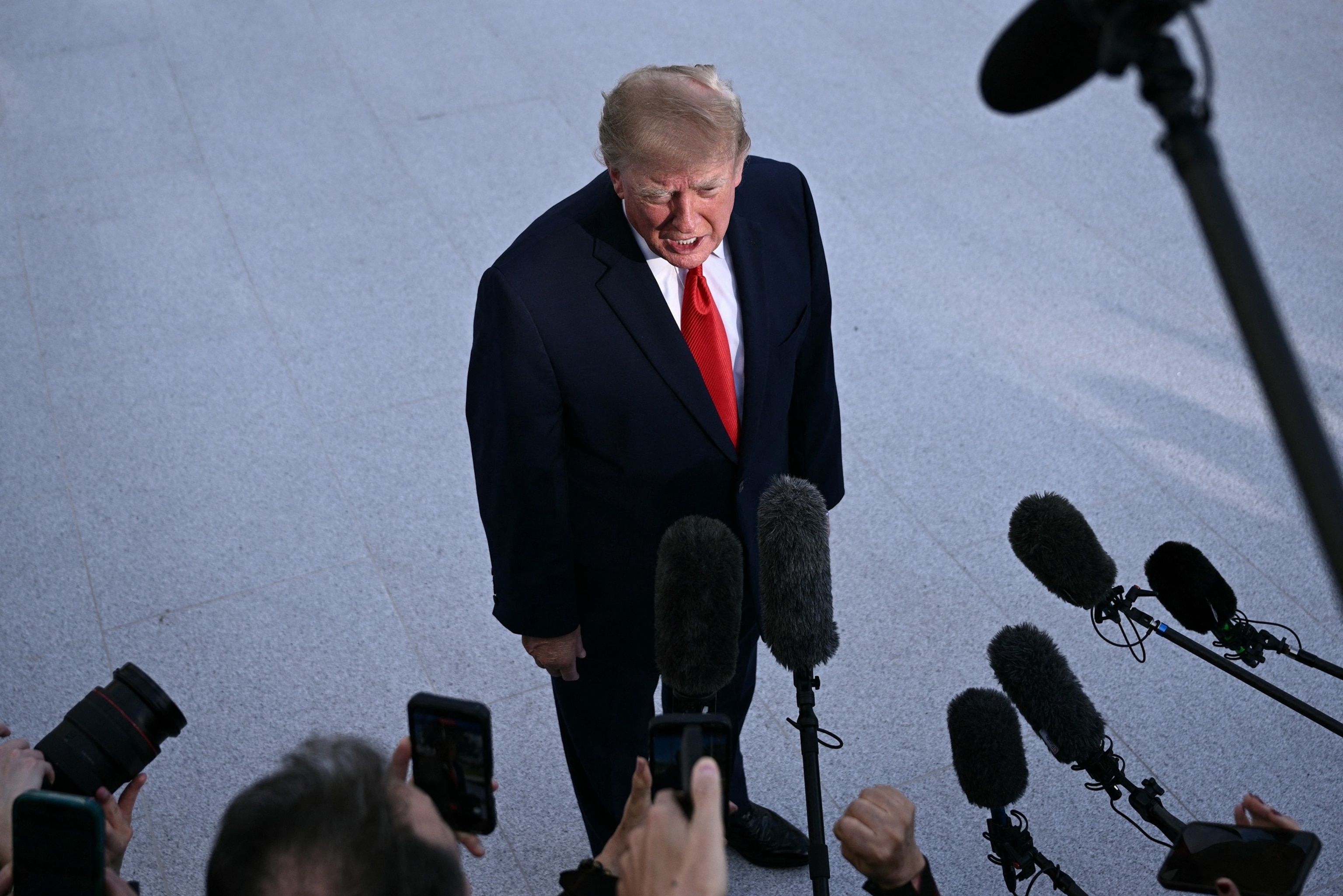 President Donald Trump speaks with reporters before walking to board Marine One