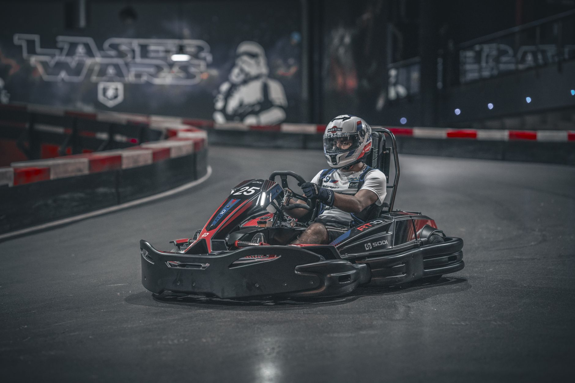 Exciting indoor go-kart racing scene with driver speeding on track.