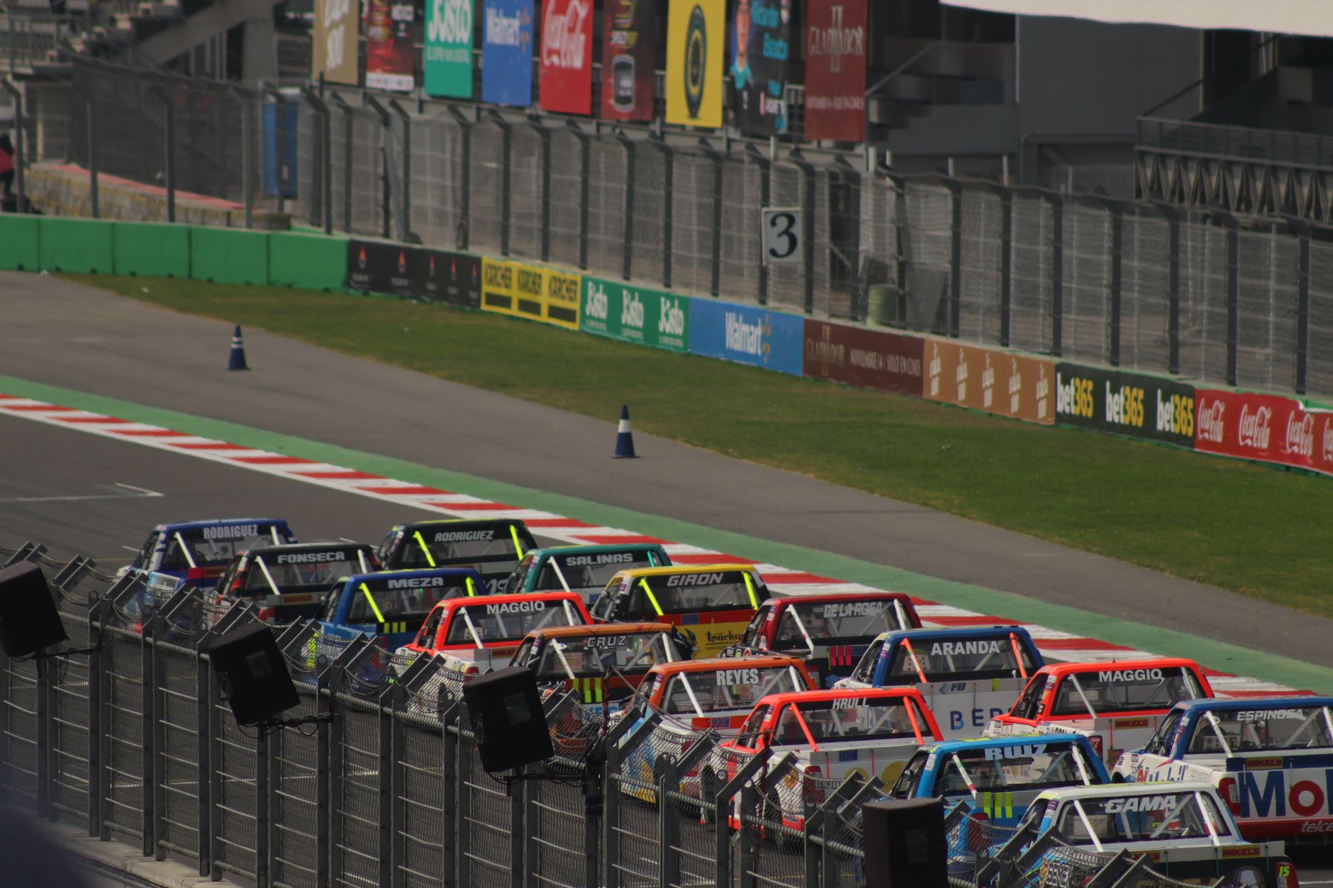 Dynamic truck race at Mexico City's famous Autódromo Hermanos Rodríguez track.