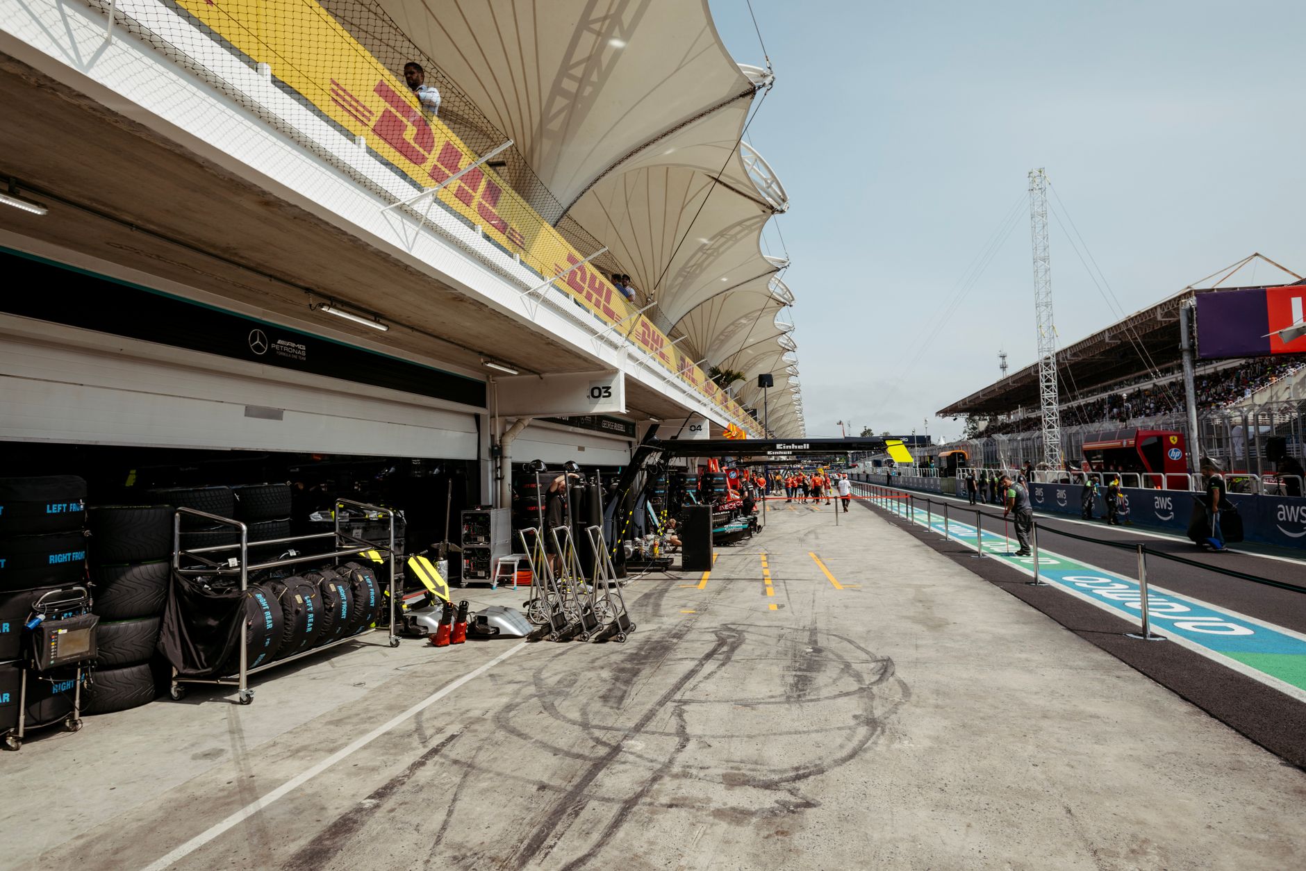 View of a Formula 1 pit lane with garage preparations and racing