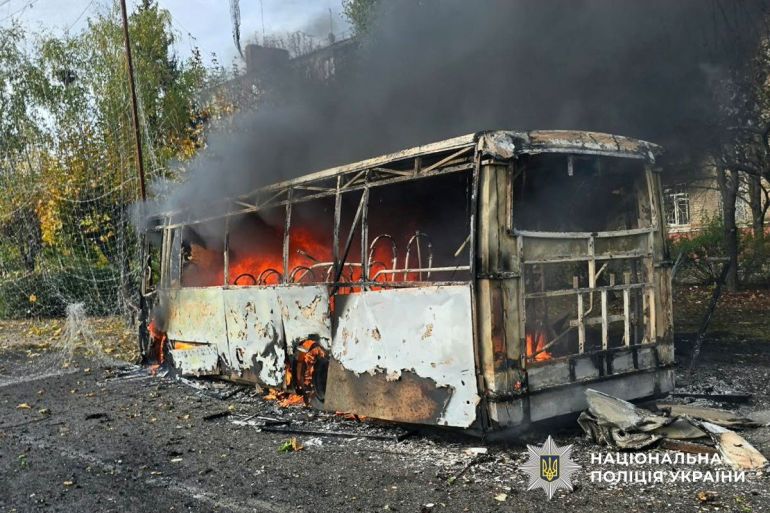 A bus burns following a Russian air strike, amid Russia’s attack on