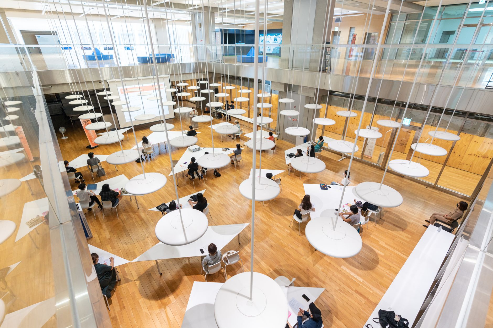 Aerial view of a contemporary study hall with unique circular tables and