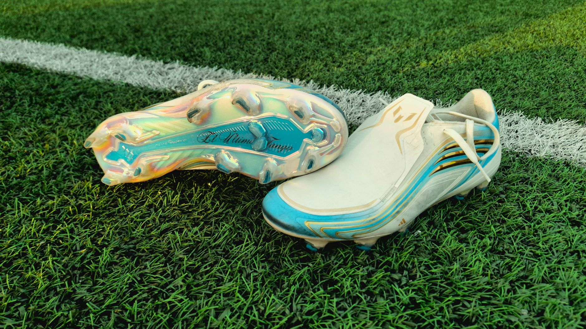 Vibrant soccer cleats on an artificial turf field, highlighting the colorful sole